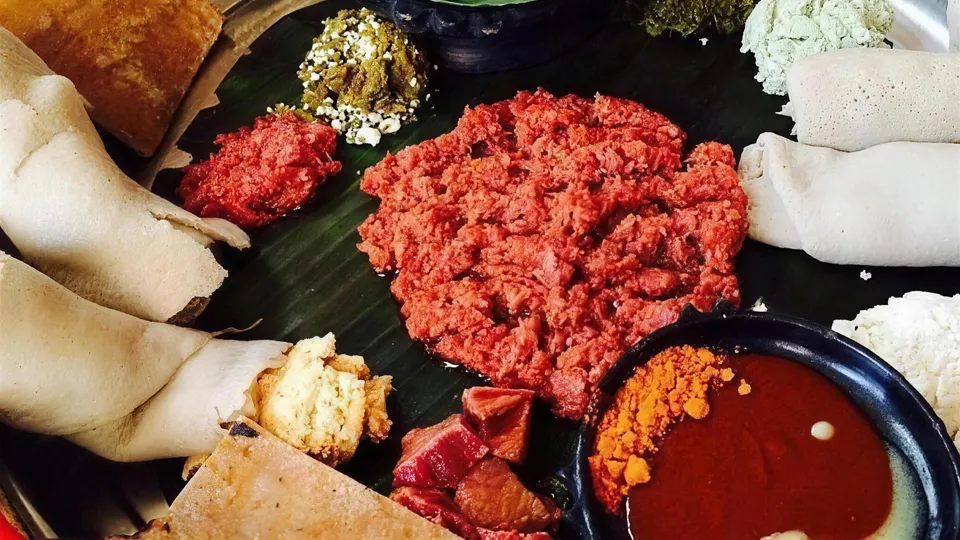 A beyaynetu fasting platter — injera topped with lentil, cabbage, beetroot and vegetable stews, the cheapest full meal in Addis Ababa