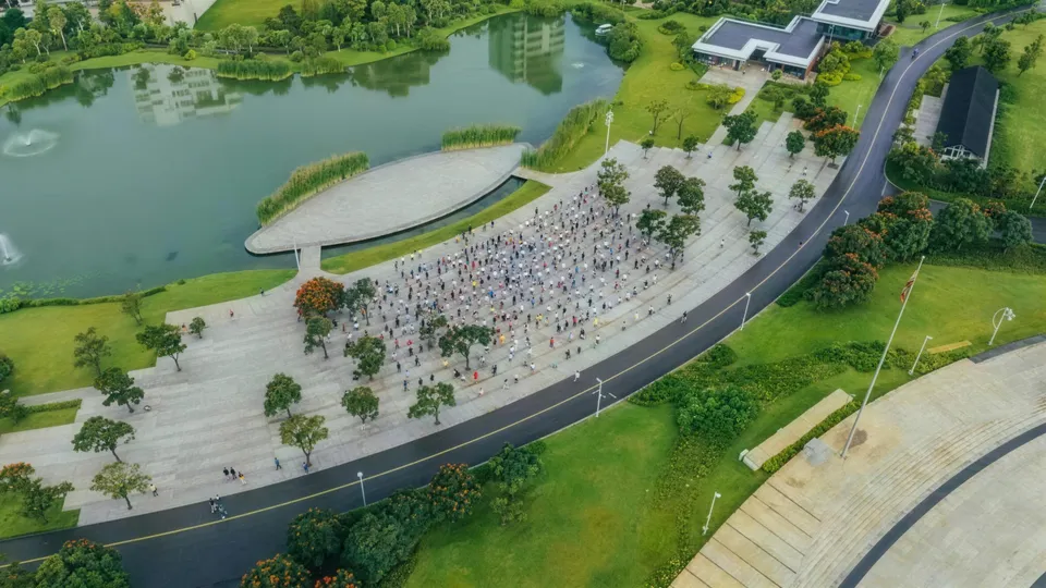 Aerial view of the Friendship Park complex — lake, plaza and lawns on the riverside corridor in central Addis Ababa